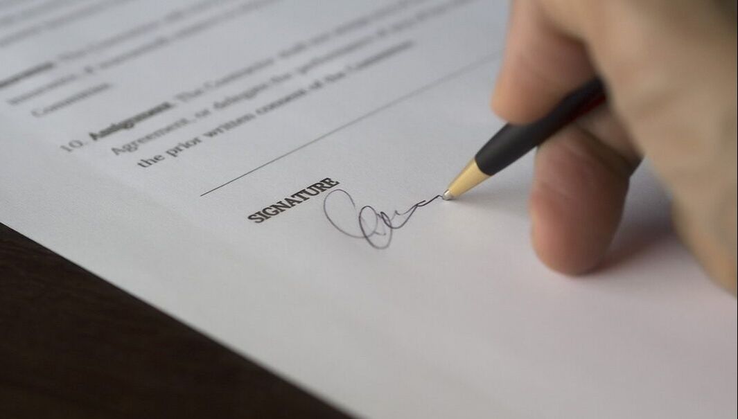 Person signing their employment contract
